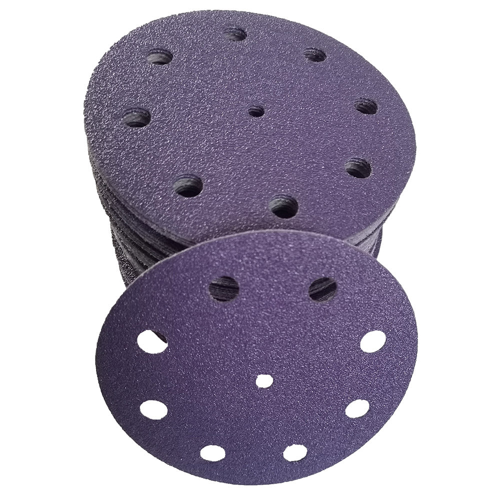 Stack of purple ceramic 5 inch 9-hole sanding discs with one disc face up