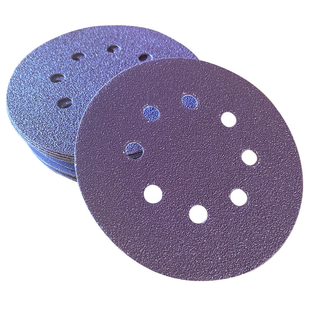 Stack of purple ceramic 5 inch 8-hole sanding discs with one disc face up showing the abrasive grain