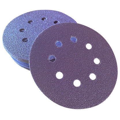 Stack of purple ceramic 5 inch 8-hole sanding discs with one disc face up showing the abrasive grain